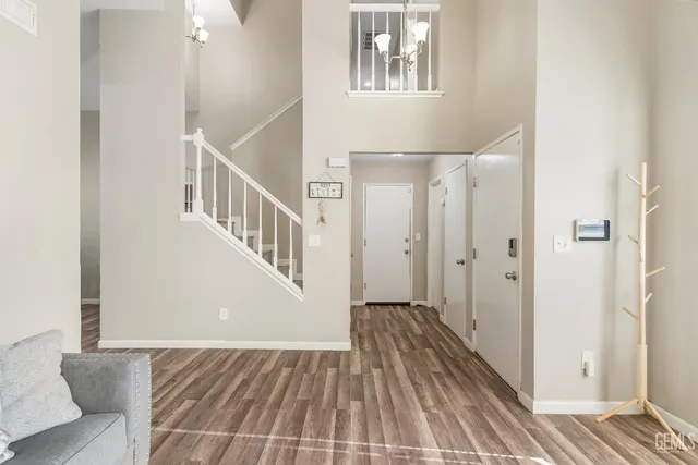 a view of a hallway with wooden floor and staircase