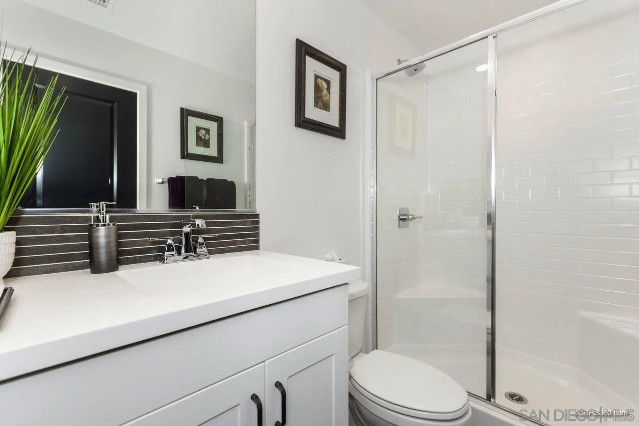 9014 Hightail Drive Santee, CA 92071 - Photo 16 of 45 a bathroom with a sink a toilet a mirror and shower