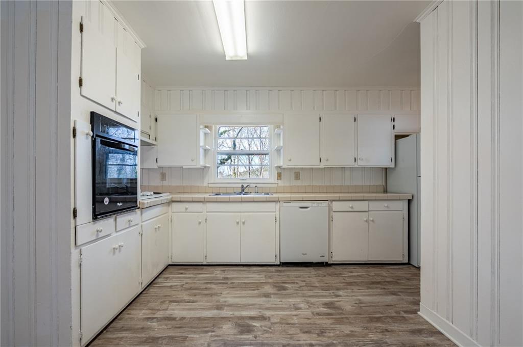 33 Summit Drive Lindale, GA 30147 - Photo 11 of 35 a kitchen with granite countertop cabinets stainless steel appliances a sink and a window