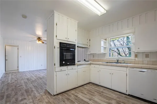 a kitchen with a sink stove and cabinets