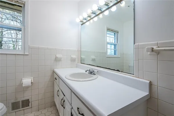 a bathroom with a sink a vanity and a mirror