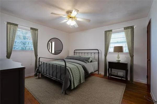 a bedroom with a bed a chandelier and dresser
