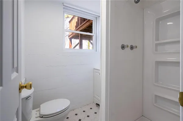a white toilet sitting next to a bathroom sink