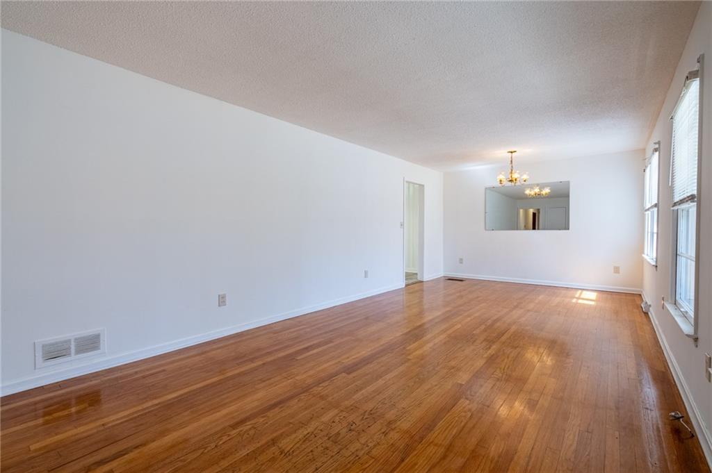 33 Summit Drive Lindale, GA 30147 - Photo 7 of 35 a view of empty room with wooden floor and fan