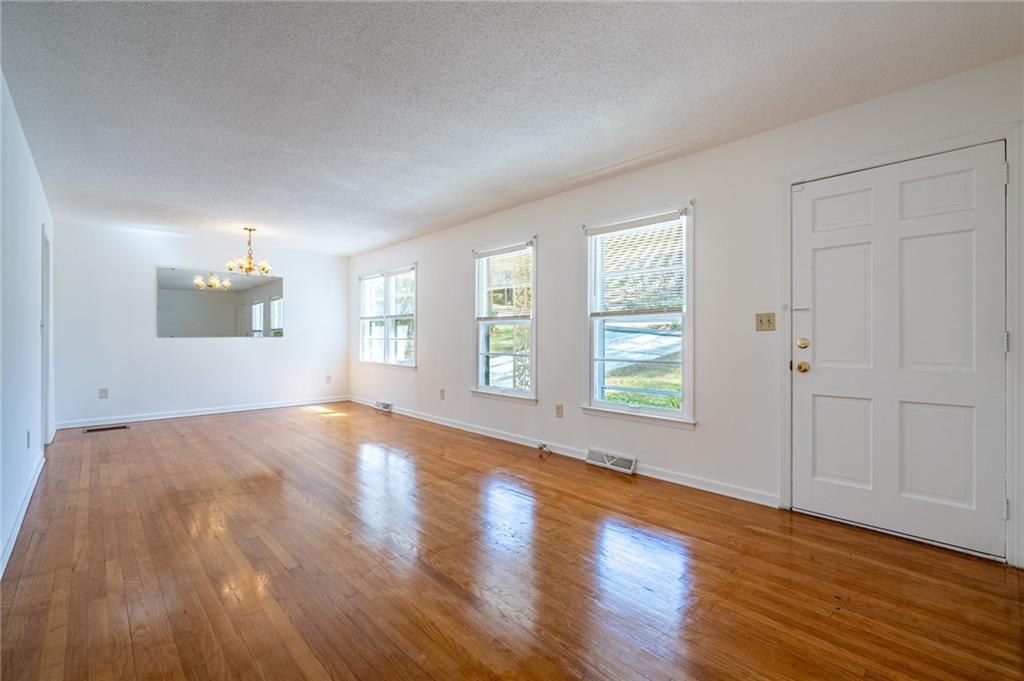 33 Summit Drive Lindale, GA 30147 - Photo 8 of 35 an empty room with wooden floor and windows