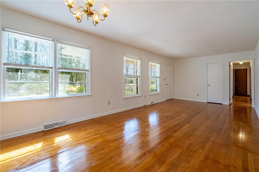 33 Summit Drive Lindale, GA 30147 - Photo 9 of 35 a view of an empty room with window and wooden floor