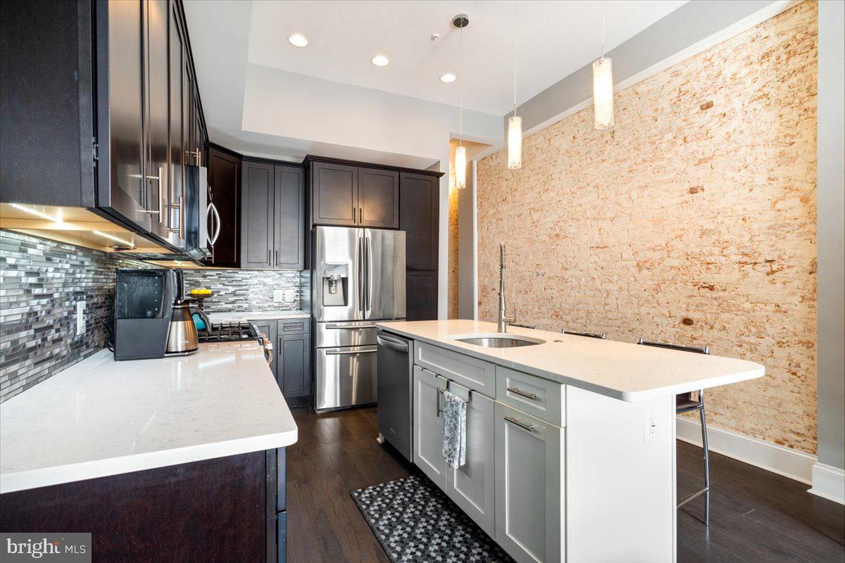 a kitchen with a sink appliances and cabinets