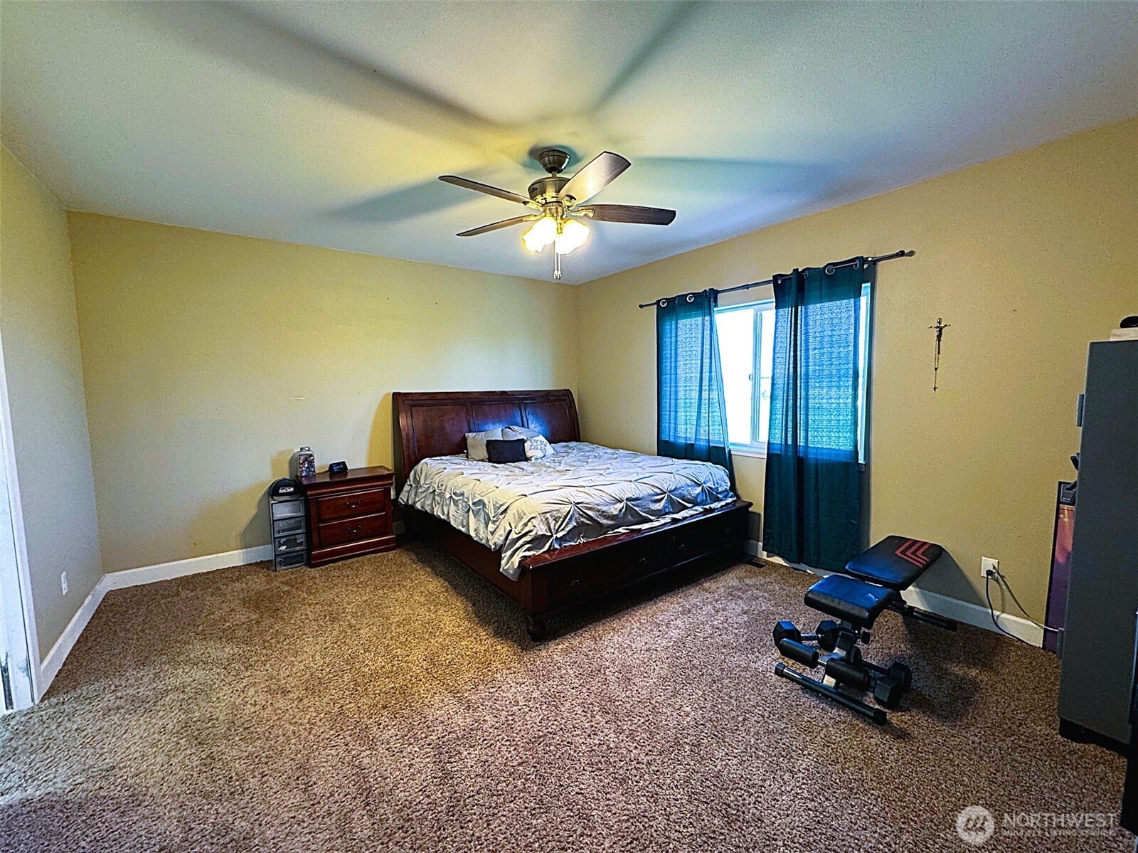849 South McKinney Road Othello, WA 99344 - Photo 13 of 39 a bedroom with a bed and a chandelier