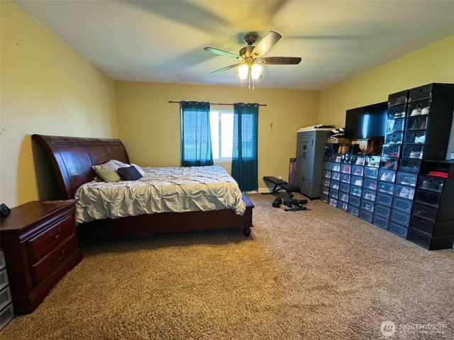 a bedroom with bed and flat tv screen on dresser
