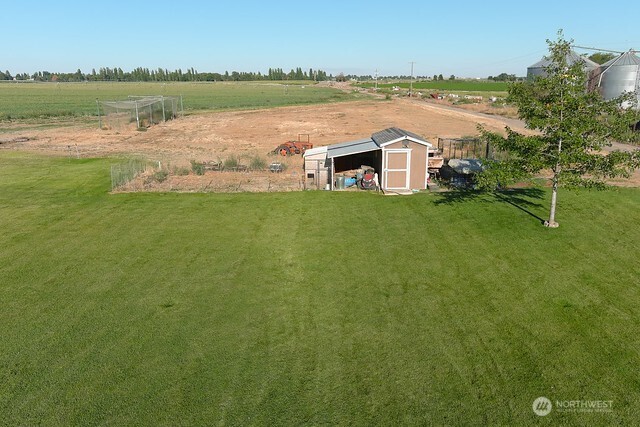 849 South McKinney Road Othello, WA 99344 - Photo 31 of 39 a view of a lake with a big yard and large trees