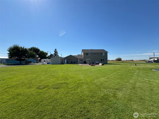 a view of a field with an trees