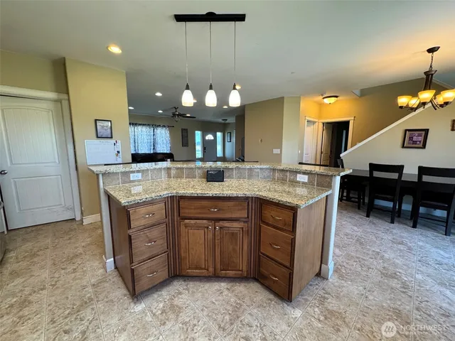 a kitchen with a sink a counter space and cabinets