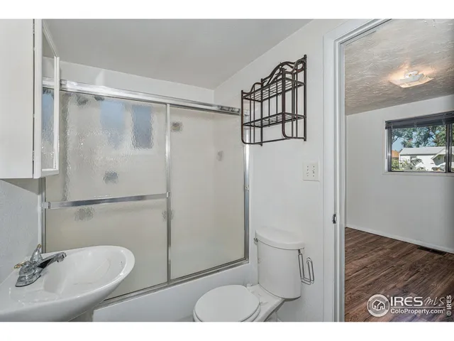 a bathroom with a toilet sink and shower