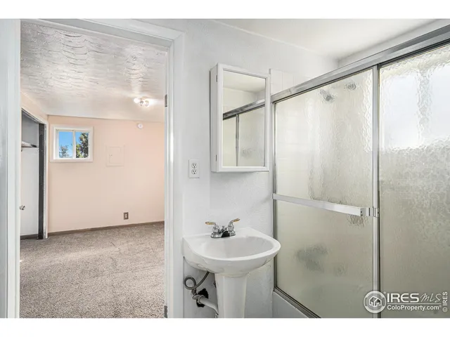 a bathroom with a sink a mirror and a shower