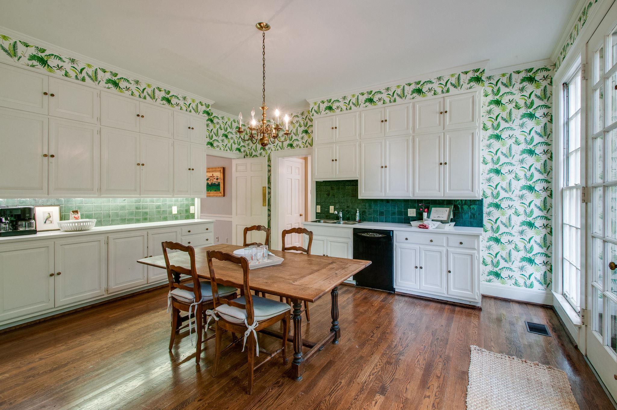 4737 Post Road Nashville, TN 37205 - Photo 14 of 30 a kitchen with stainless steel appliances a table chairs and a white wooden cabinets