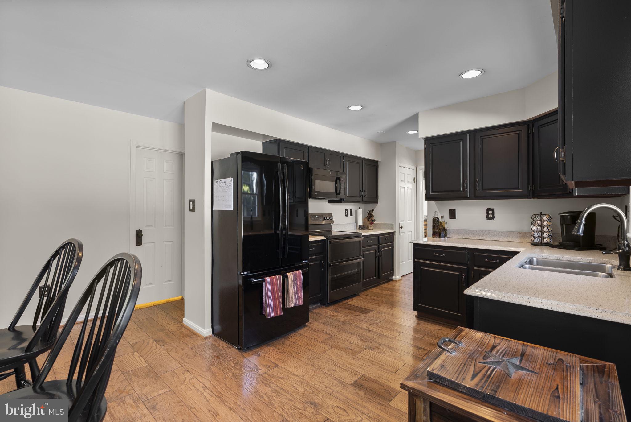 16424 Montecrest Lane Gaithersburg, MD 20878 - Photo 17 of 91 a kitchen with stainless steel appliances granite countertop a refrigerator stove microwave and sink