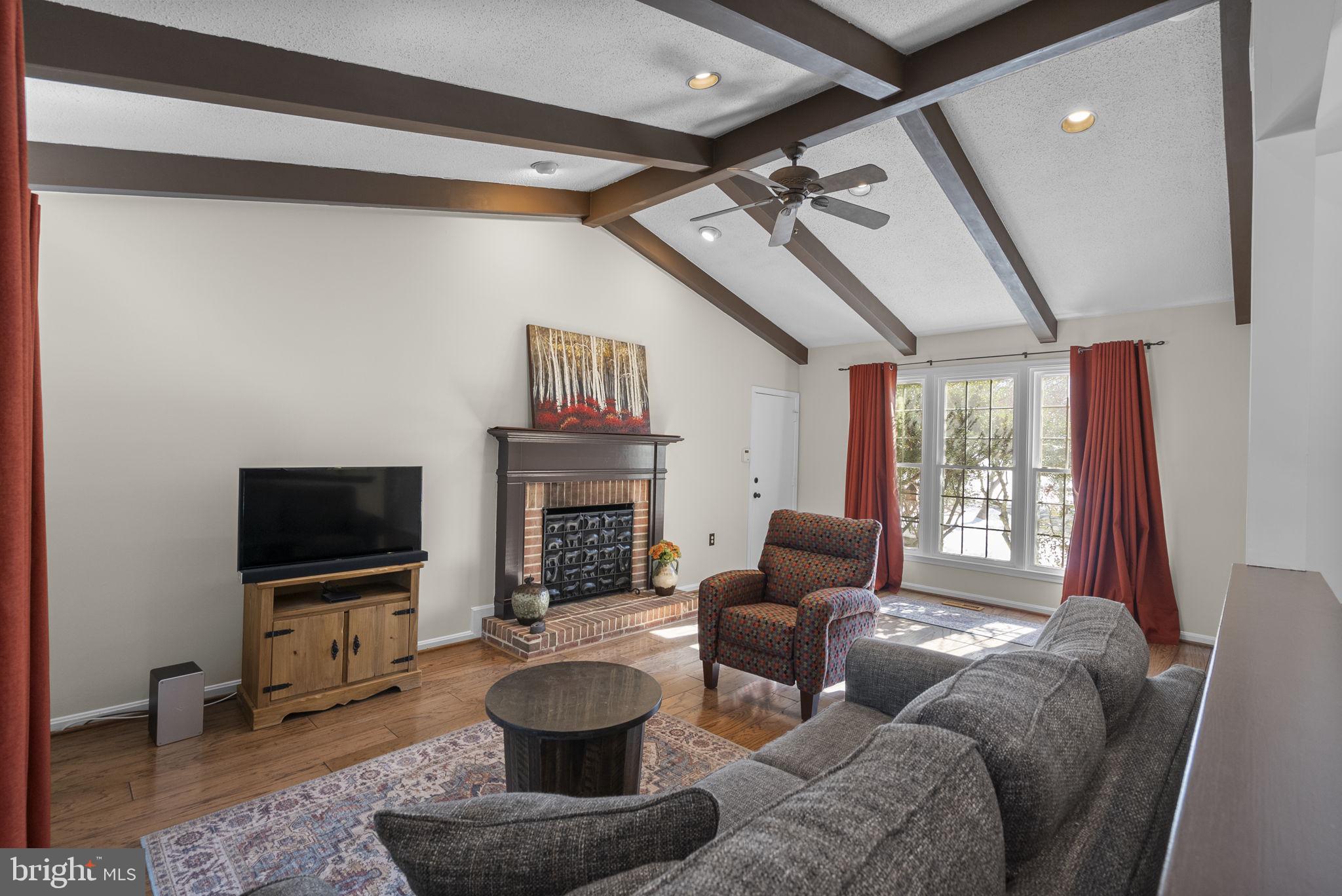 16424 Montecrest Lane Gaithersburg, MD 20878 - Photo 23 of 91 a living room with furniture a flat screen tv and a fireplace