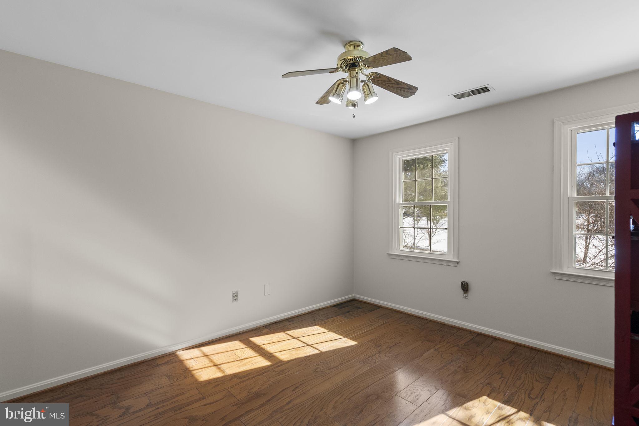 16424 Montecrest Lane Gaithersburg, MD 20878 - Photo 32 of 91 a view of empty room with wooden floor and fan