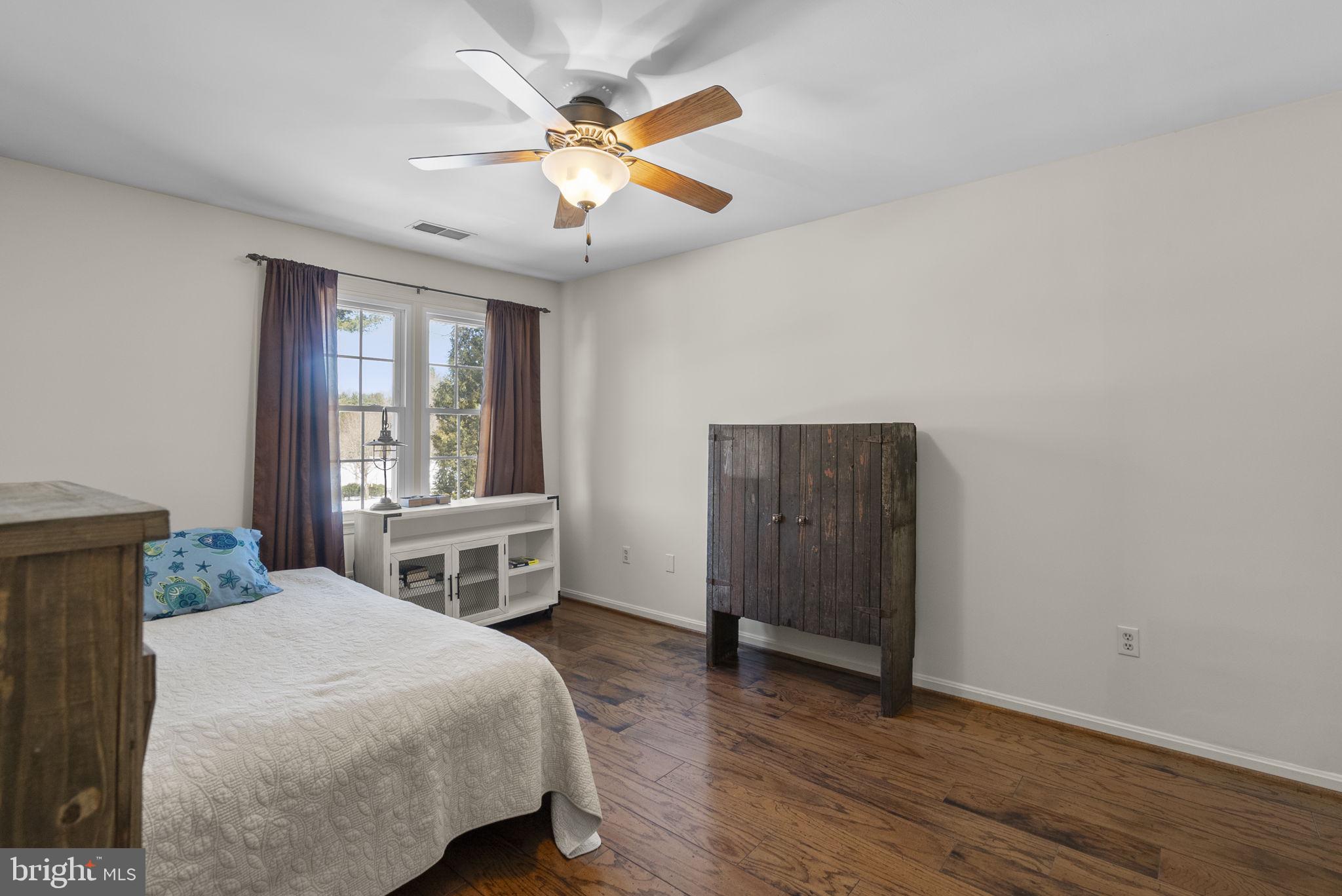 16424 Montecrest Lane Gaithersburg, MD 20878 - Photo 34 of 91 a bedroom with a bed and a chandelier