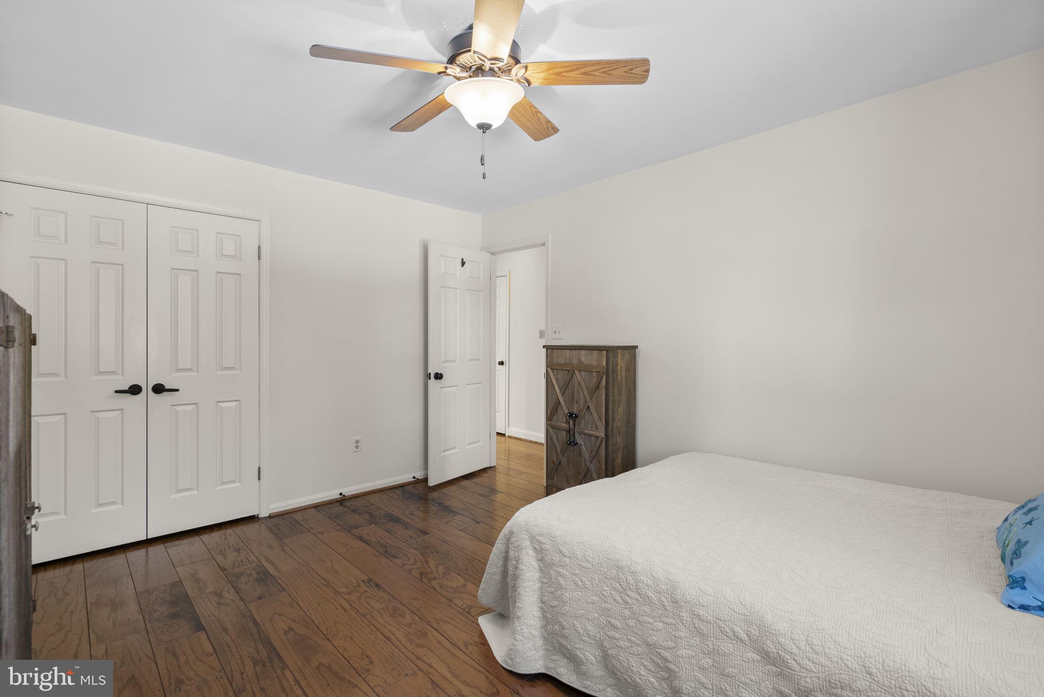 16424 Montecrest Lane Gaithersburg, MD 20878 - Photo 35 of 91 a bedroom with a bed and a chandelier