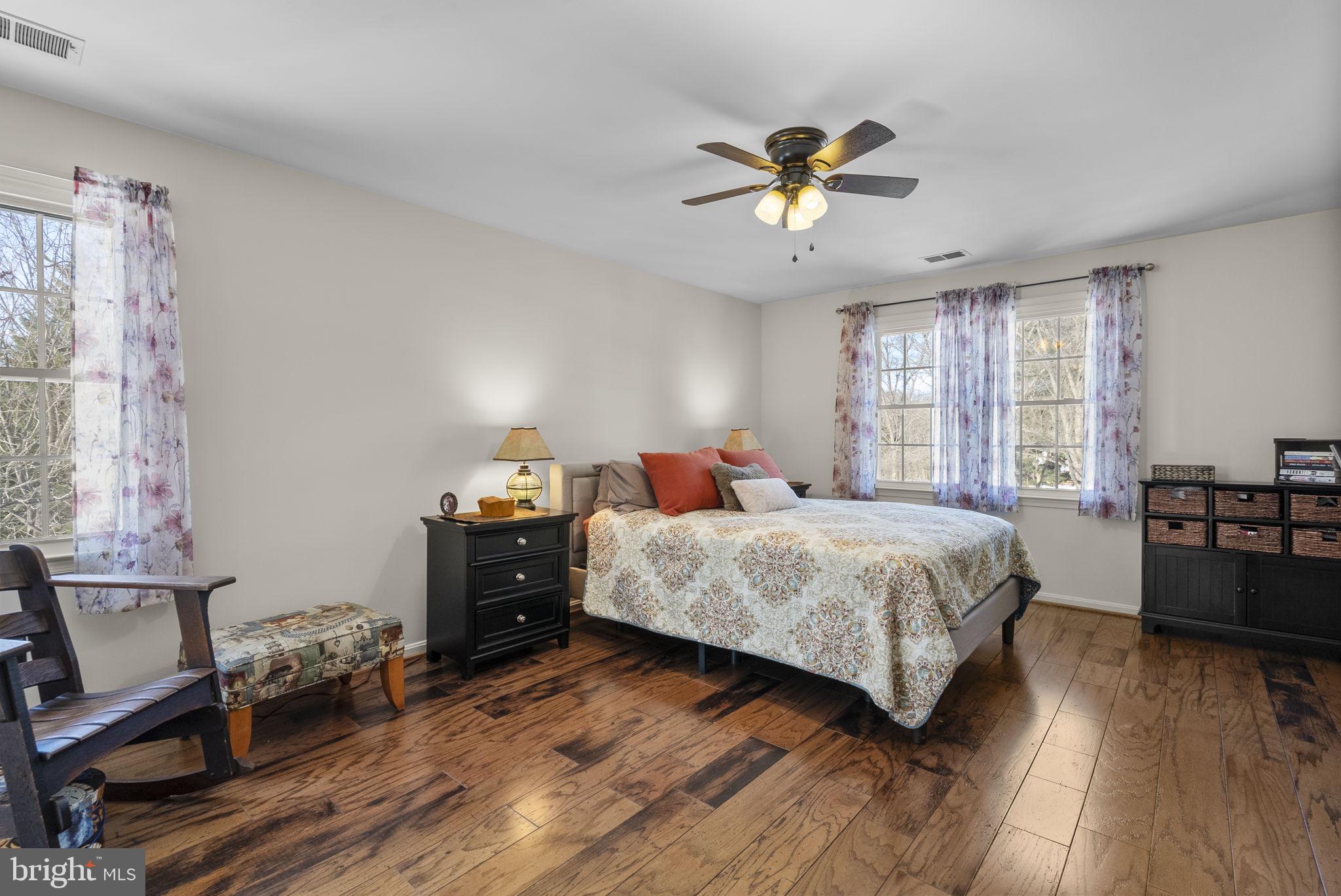 16424 Montecrest Lane Gaithersburg, MD 20878 - Photo 37 of 91 a bedroom with a bed and wooden floor