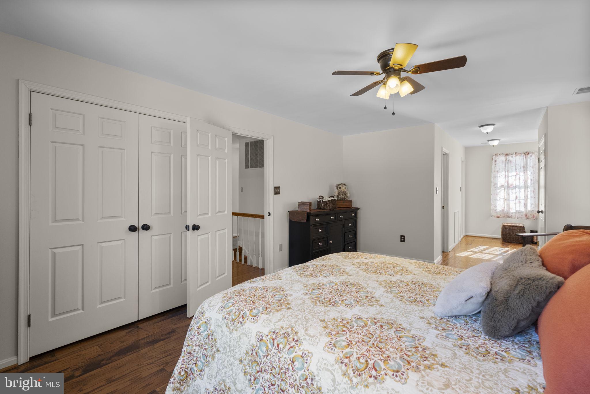 16424 Montecrest Lane Gaithersburg, MD 20878 - Photo 40 of 91 a bedroom with a bed and a chandelier