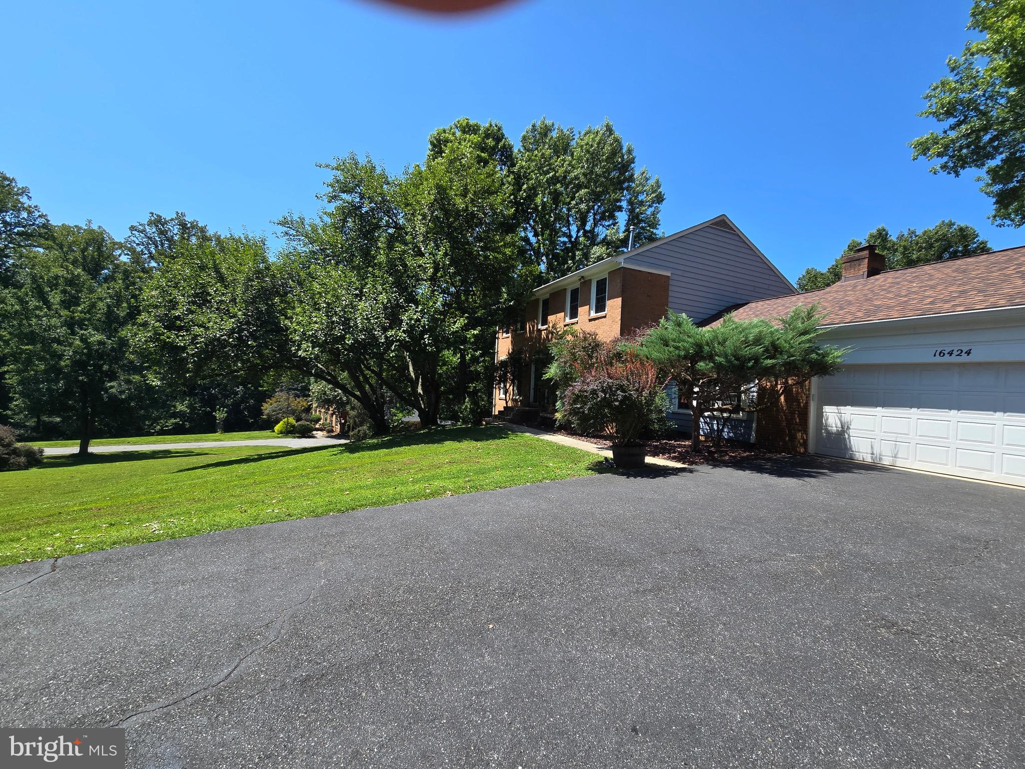 16424 Montecrest Lane Gaithersburg, MD 20878 - Photo 80 of 91 a front view of a house with a yard and garage