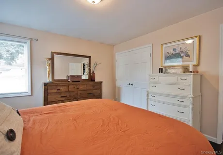 a bathroom with a granite countertop sink a toilet and mirror