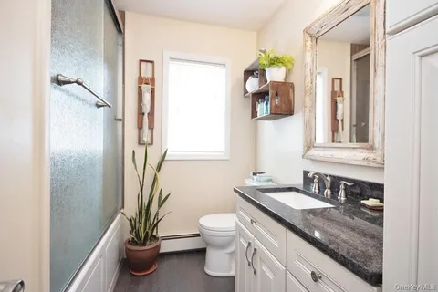 a view of a hallway with furniture and windows
