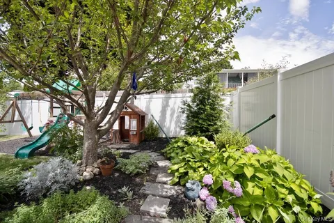 a view of backyard of the house with outdoor seating