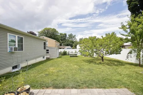 a view of patio with table and chairs under an umbrella