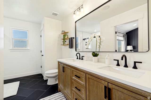 983 West 1550th Street South Springville, UT 84663 - Photo 25 of 43 Contemporary bathroom featuring a double vanity with light wood-finish cabinetry and white countertops.