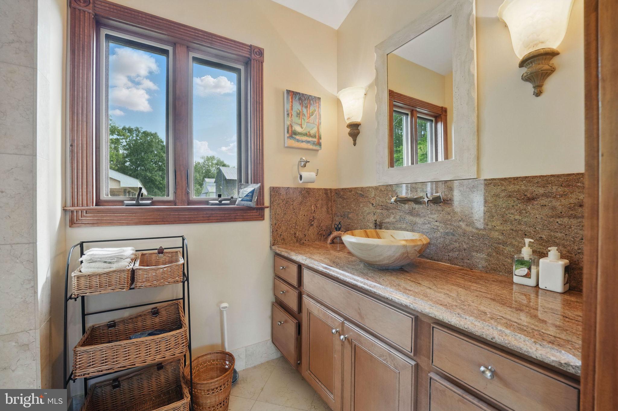 8511 Leeds Manor Road Warrenton, VA 20186 - Photo 23 of 36 a bathroom with a granite countertop sink and a mirror