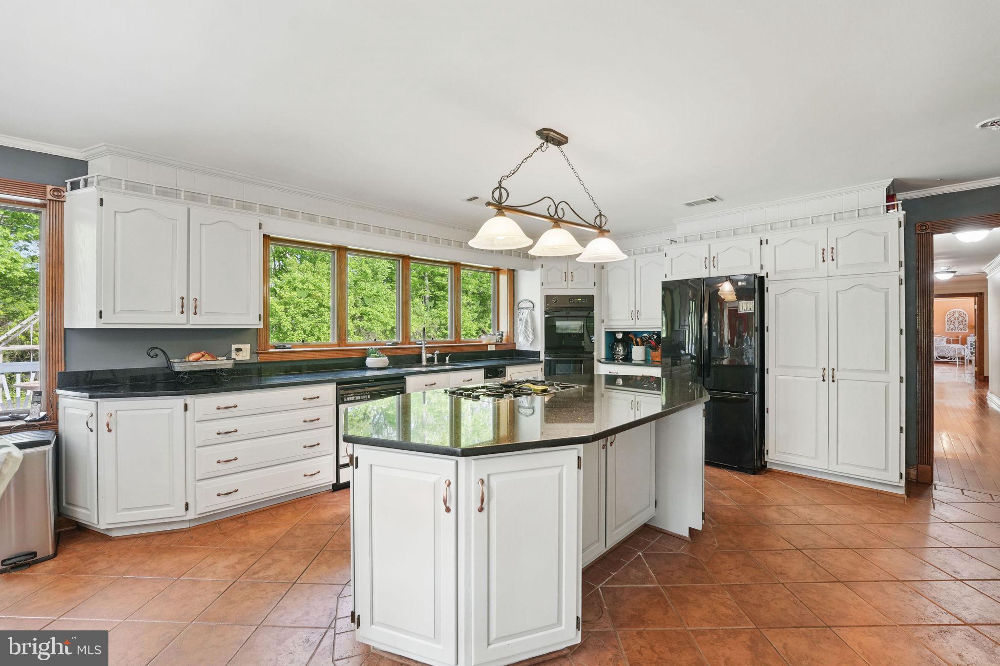 8511 Leeds Manor Road Warrenton, VA 20186 - Photo 6 of 36 a kitchen with stainless steel appliances granite countertop a sink a stove and a refrigerator