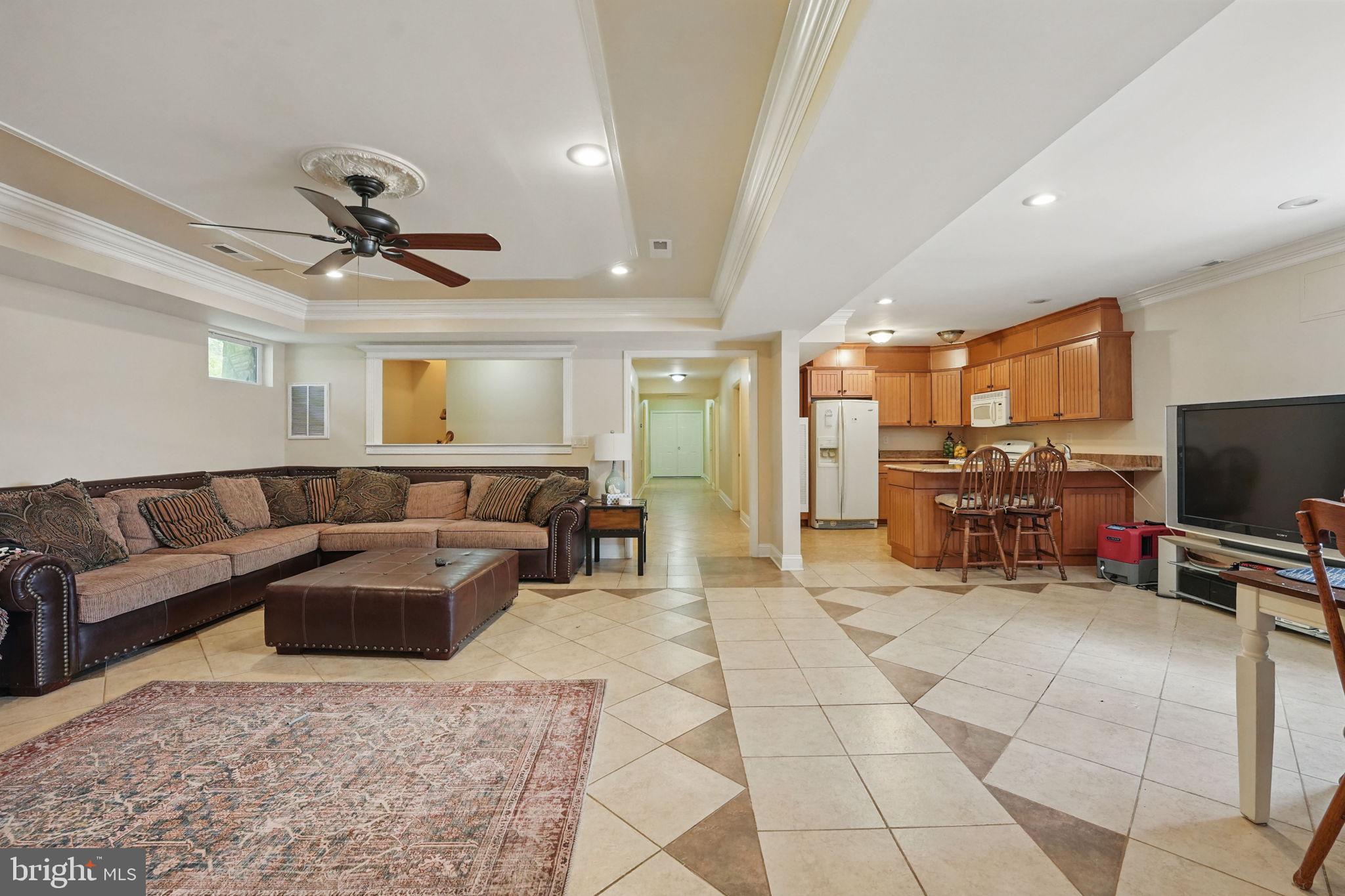 8511 Leeds Manor Road Warrenton, VA 20186 - Photo 8 of 36 a living room with furniture and a flat screen tv