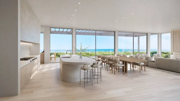a terrace with outdoor seating and ocean view