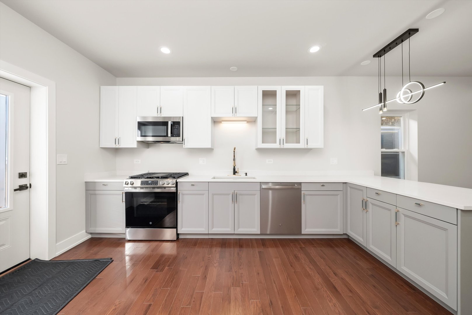 1631 North Parkside Avenue Chicago, IL 60639 - Photo 11 of 33 a kitchen with stainless steel appliances granite countertop a stove a sink and a microwave