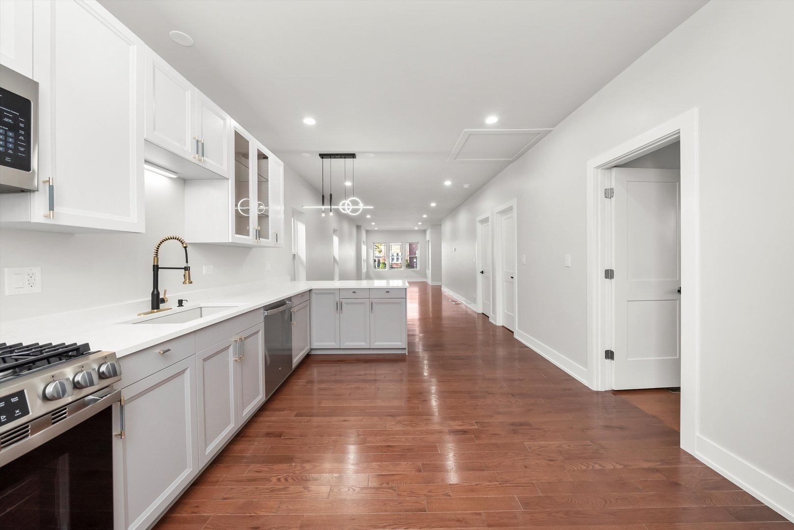 1631 North Parkside Avenue Chicago, IL 60639 - Photo 12 of 33 a large kitchen with stainless steel appliances and white cabinets
