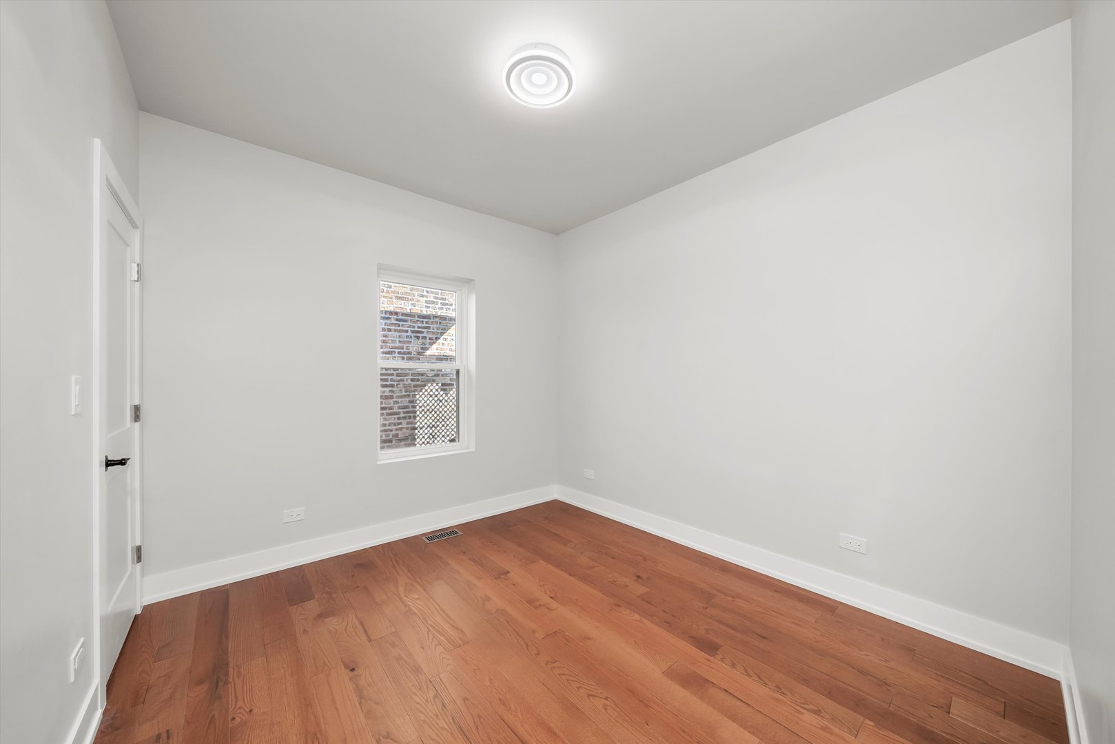 1631 North Parkside Avenue Chicago, IL 60639 - Photo 13 of 33 an empty room with wooden floor and windows
