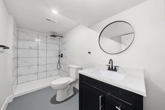 a bathroom with a sink a toilet and a mirror