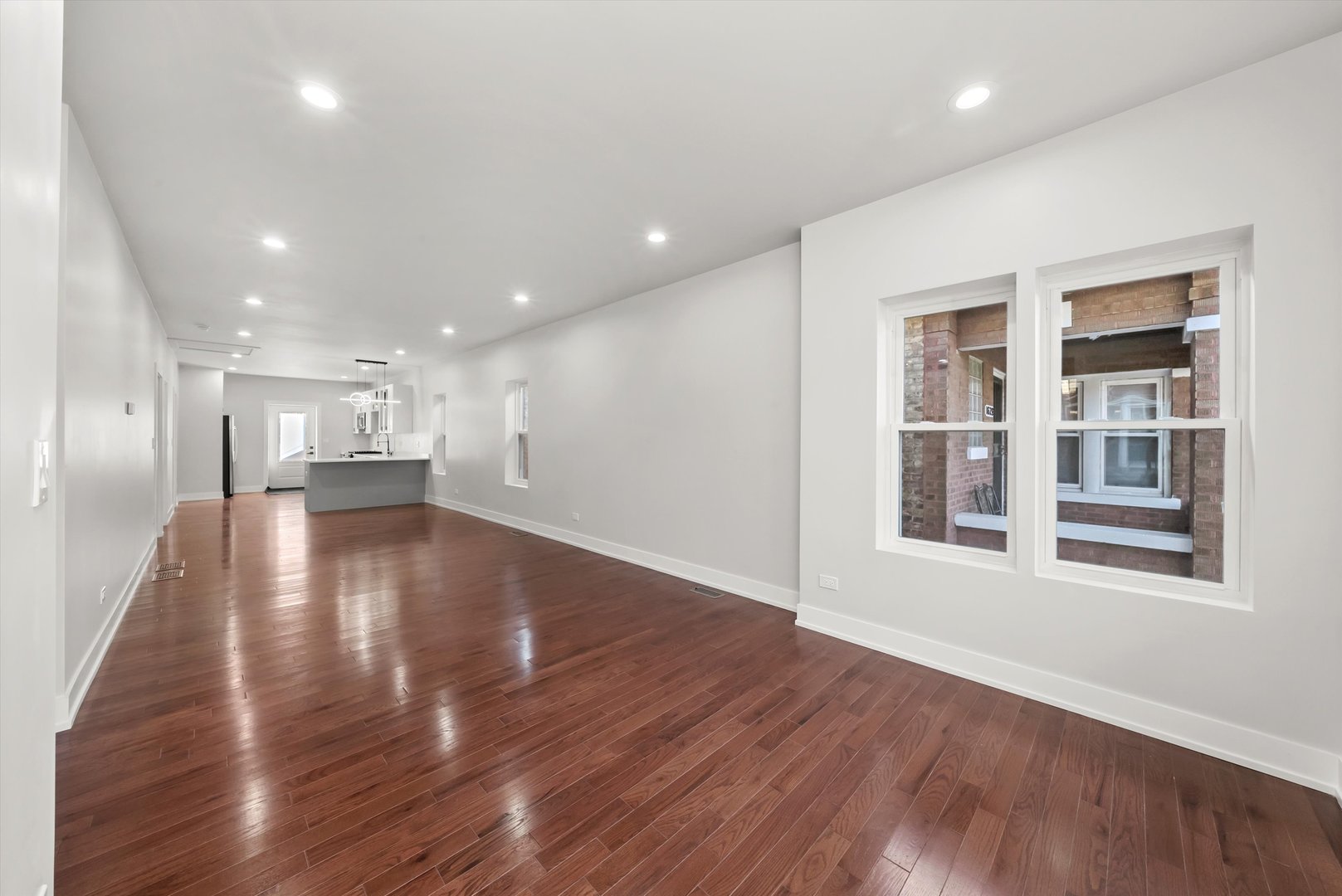 1631 North Parkside Avenue Chicago, IL 60639 - Photo 2 of 33 a view of an empty room with wooden floor and a window
