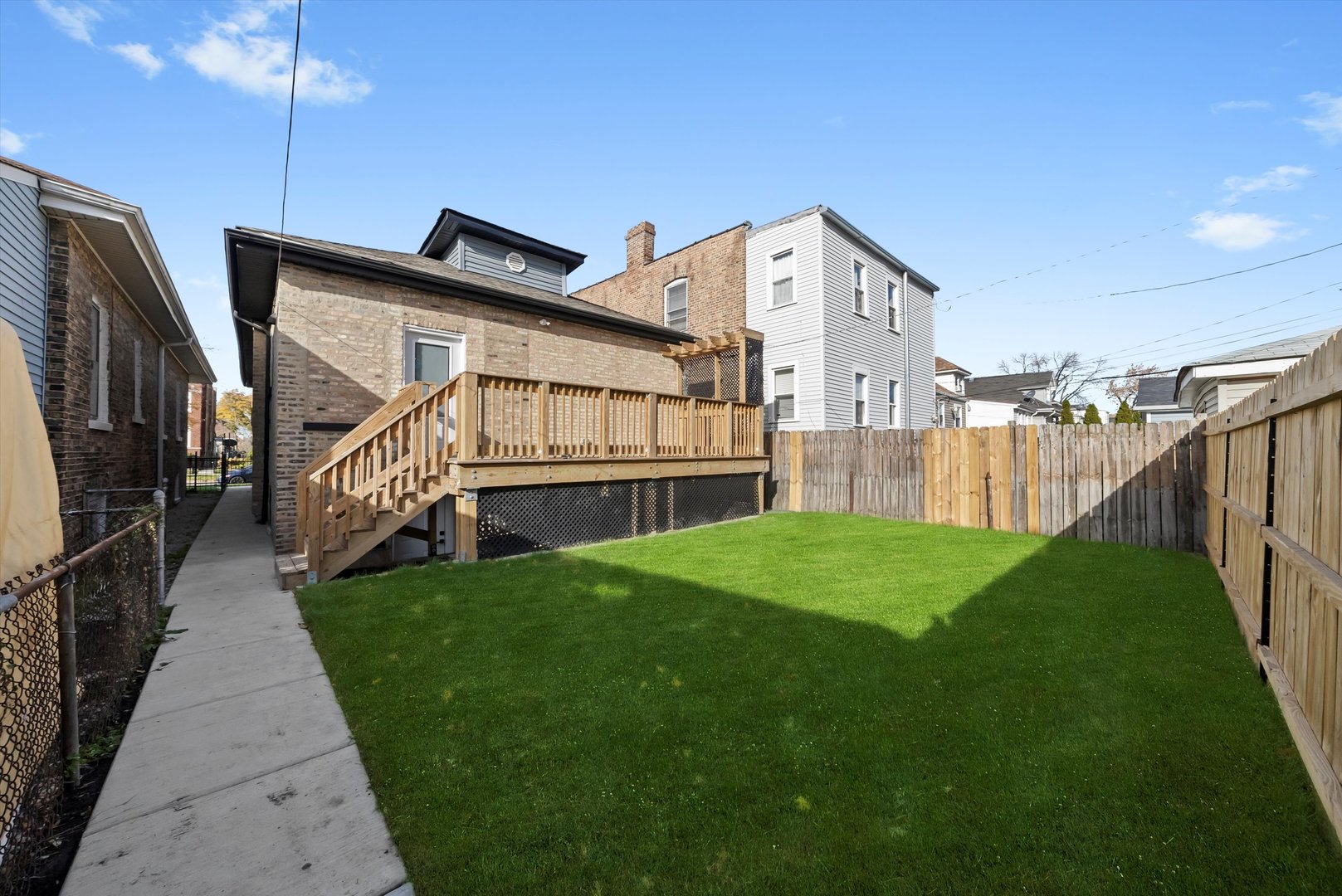 1631 North Parkside Avenue Chicago, IL 60639 - Photo 26 of 33 a view of an house with backyard and deck