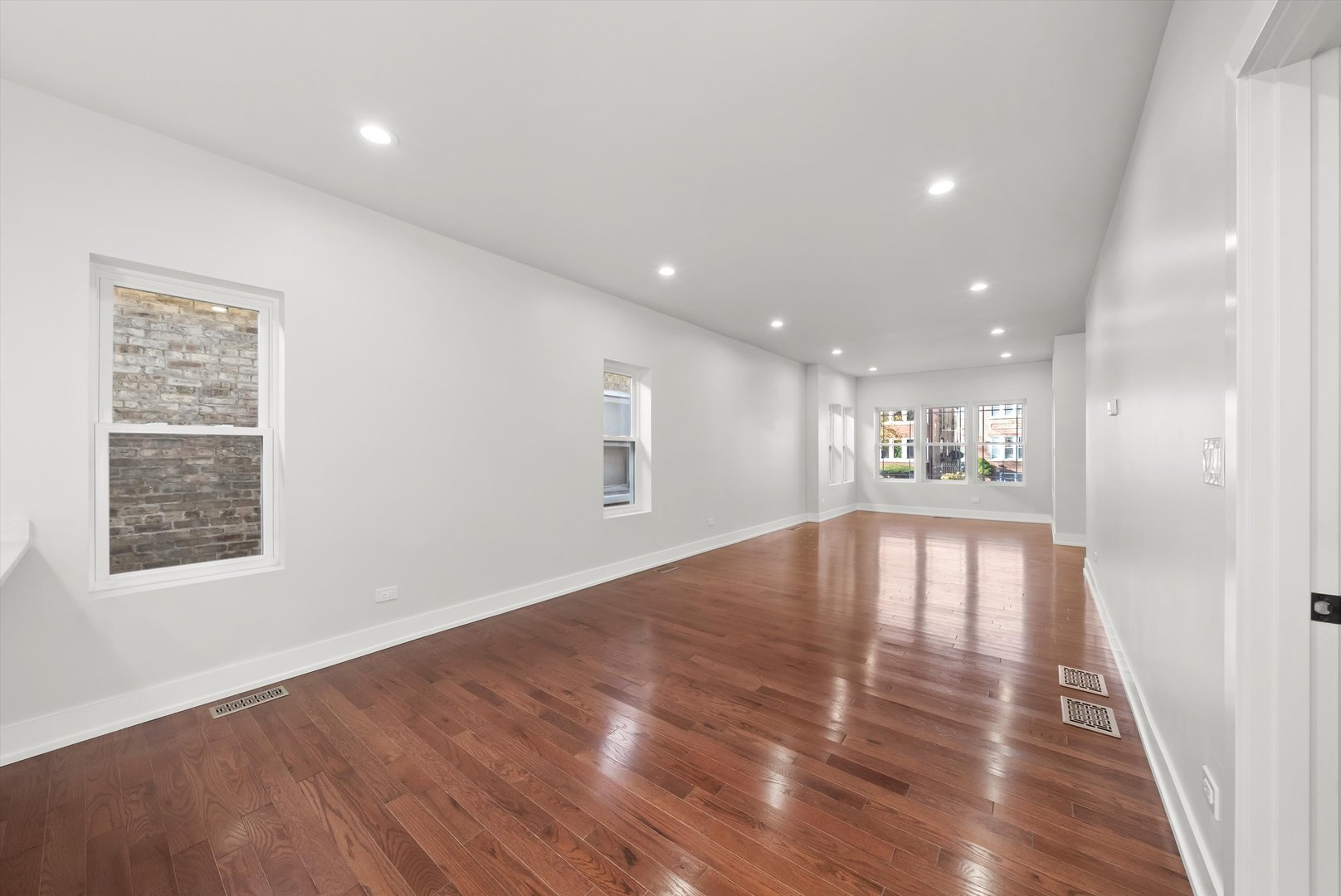 1631 North Parkside Avenue Chicago, IL 60639 - Photo 6 of 33 a view of an empty room with wooden floor and a window
