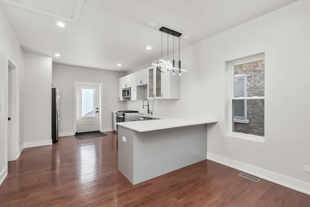 a view of kitchen with sink and wooden floor