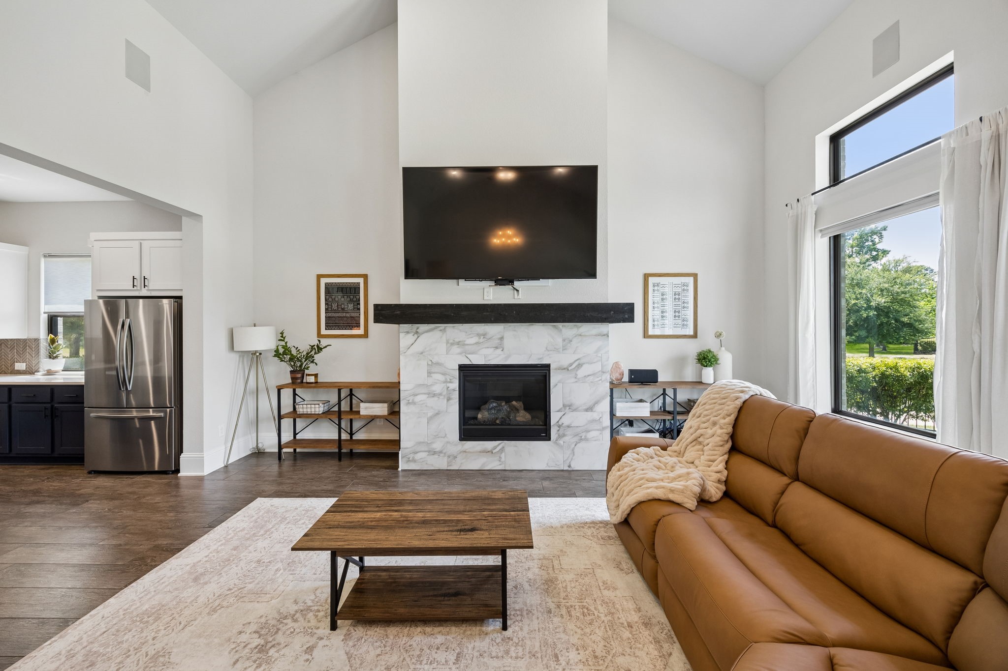 10102 South Goshawk Trail Conroe, TX 77385 - Photo 5 of 46 a living room with furniture a flat screen tv and a fireplace