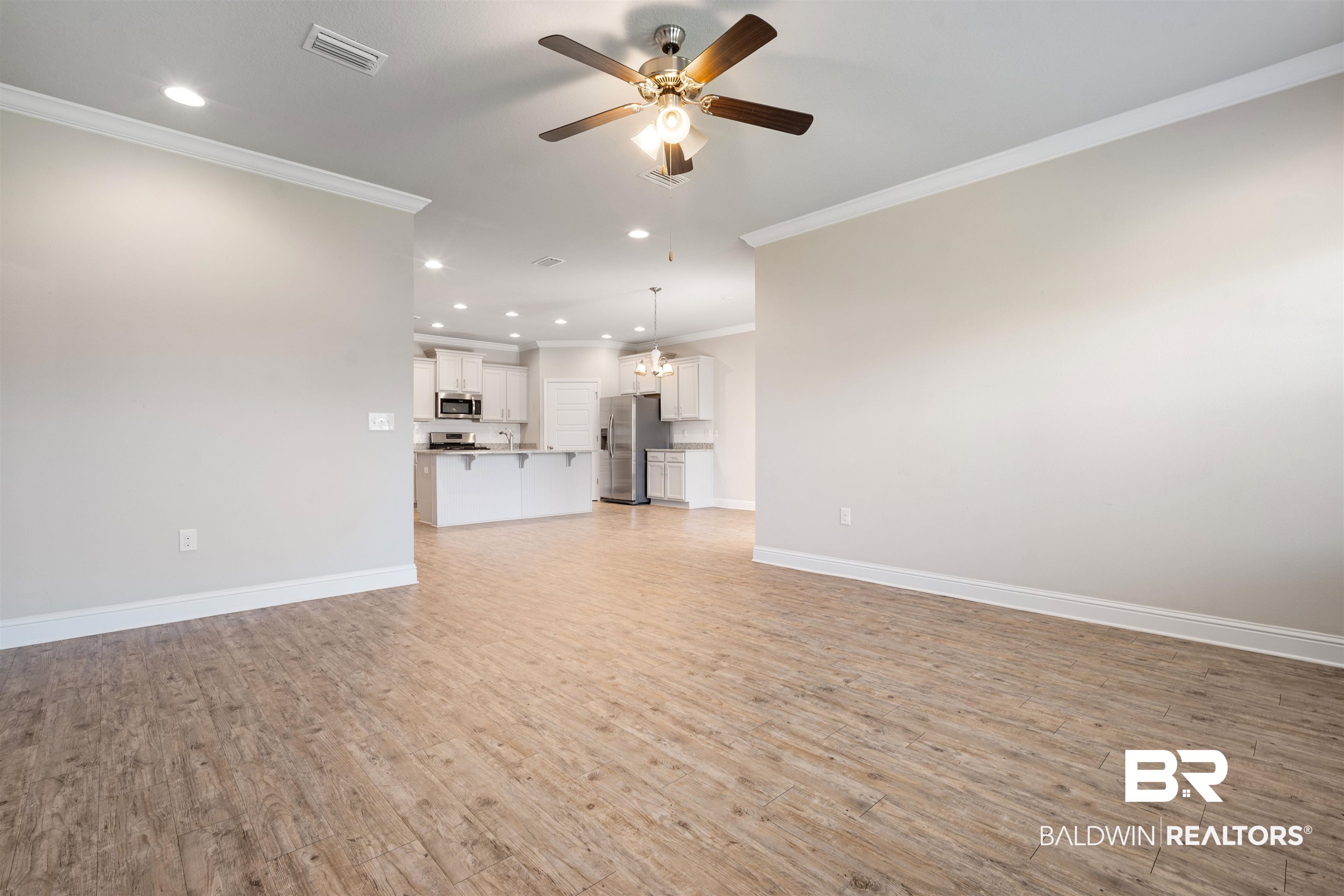 24479 Kipling Court Daphne, AL 36526 - Photo 4 of 41 Unfurnished living room featuring recessed lighting, light wood-type flooring, crown molding, and ceiling fan