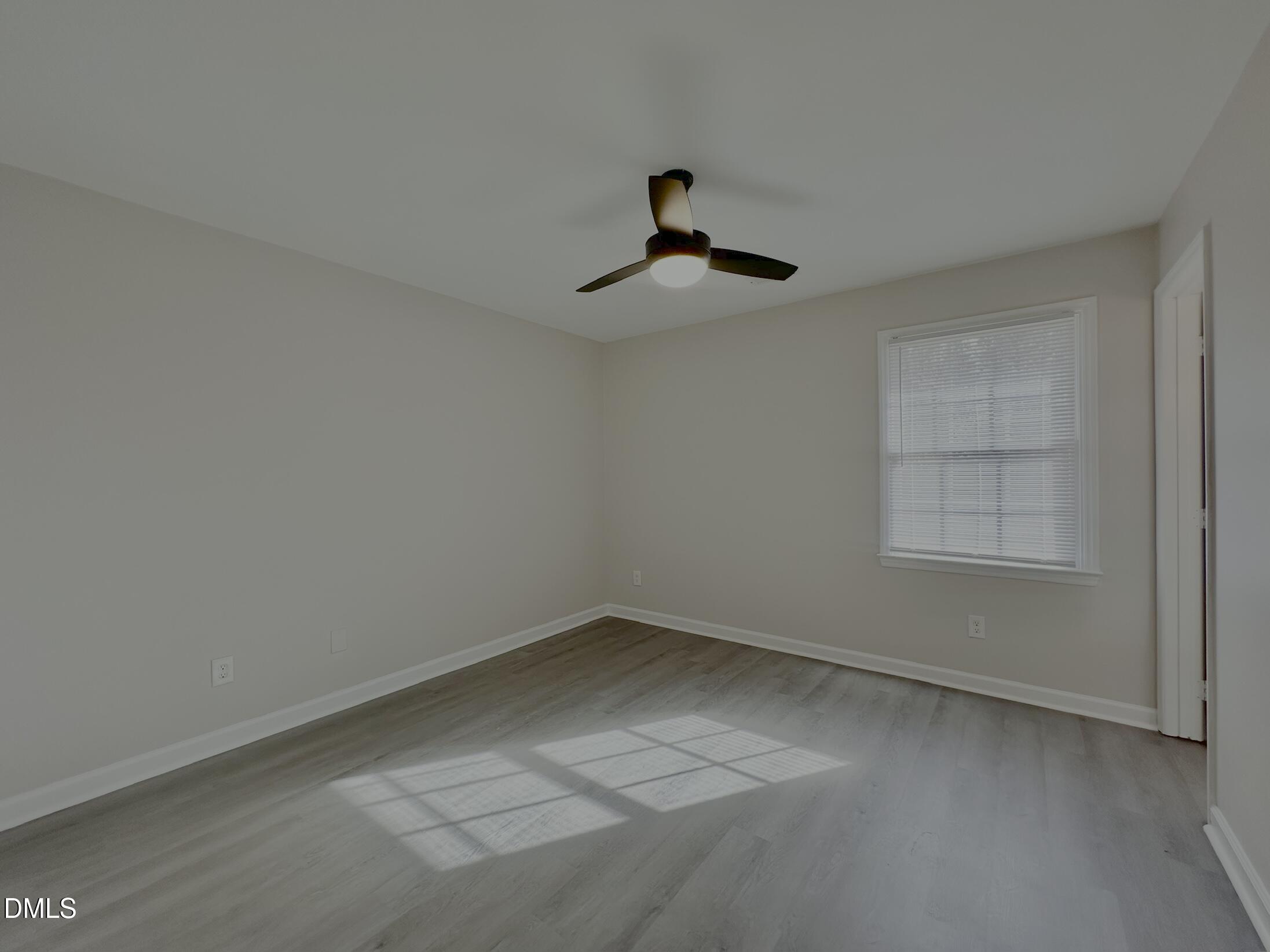 420 Tippett Road Zebulon, NC 27597 - Photo 11 of 14 a view of empty room with wooden floor and fan