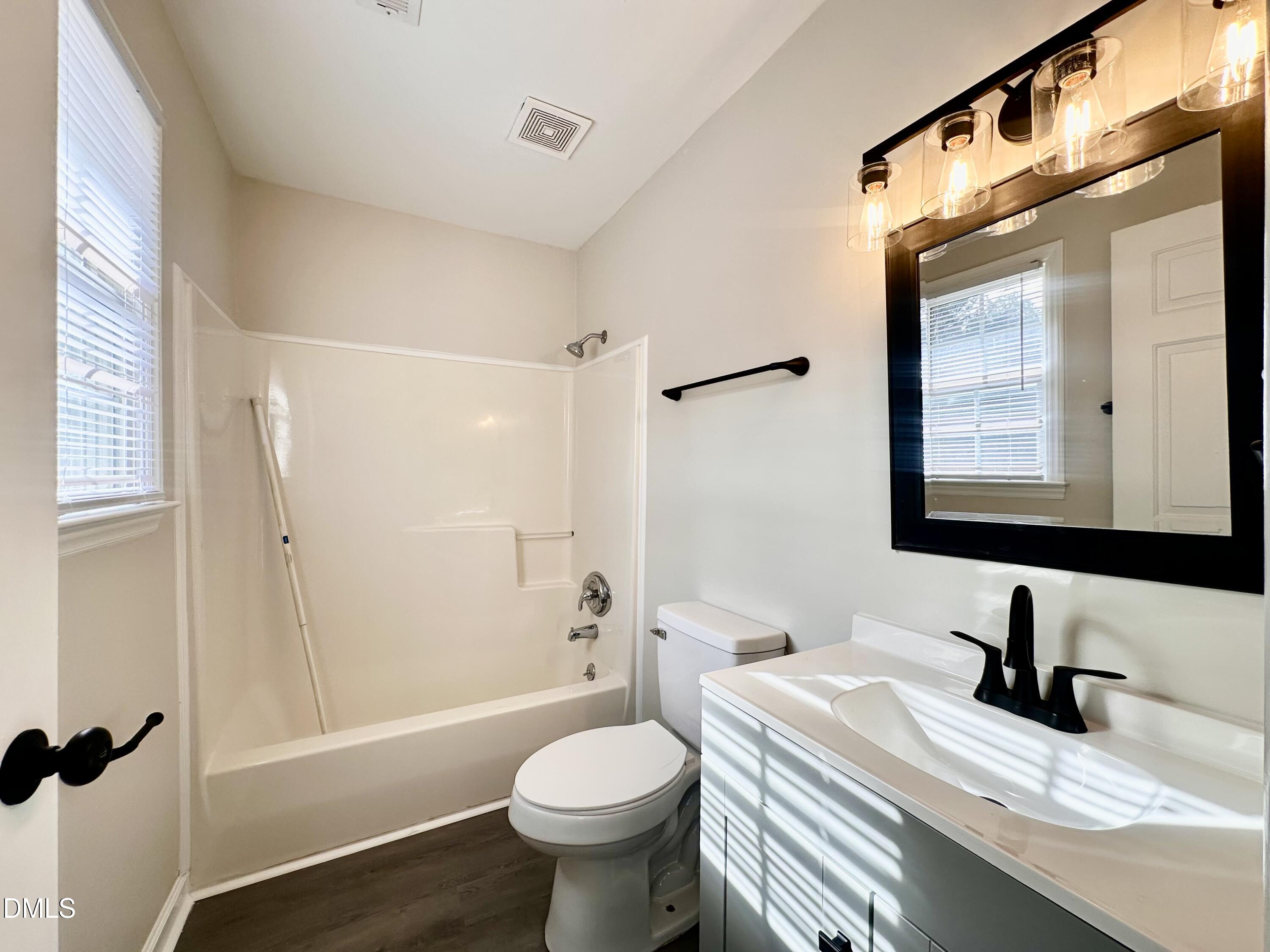420 Tippett Road Zebulon, NC 27597 - Photo 12 of 14 a bathroom with a sink toilet and shower