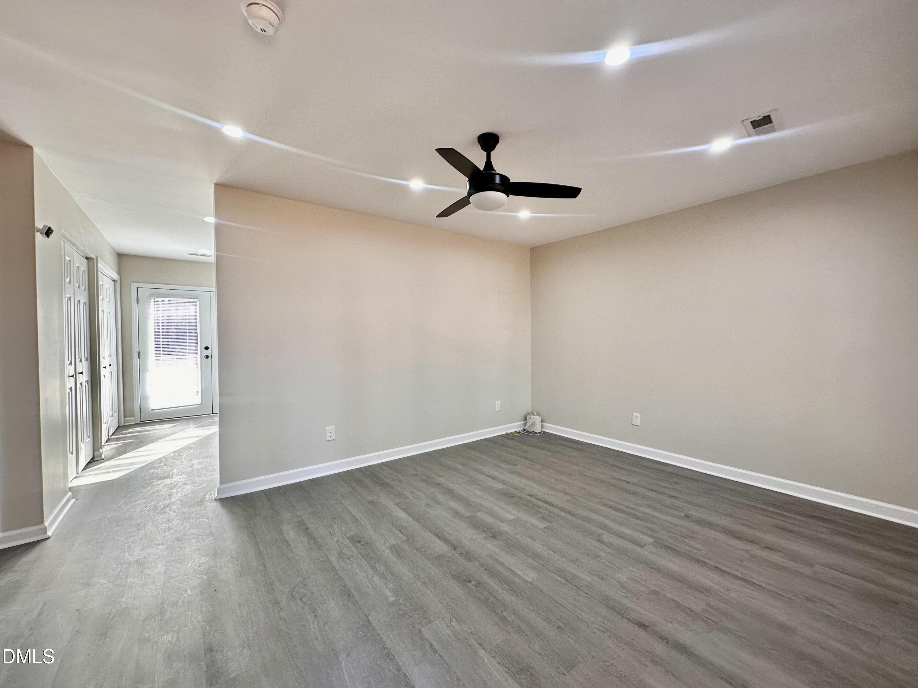 420 Tippett Road Zebulon, NC 27597 - Photo 6 of 14 a view of an empty room with wooden floor
