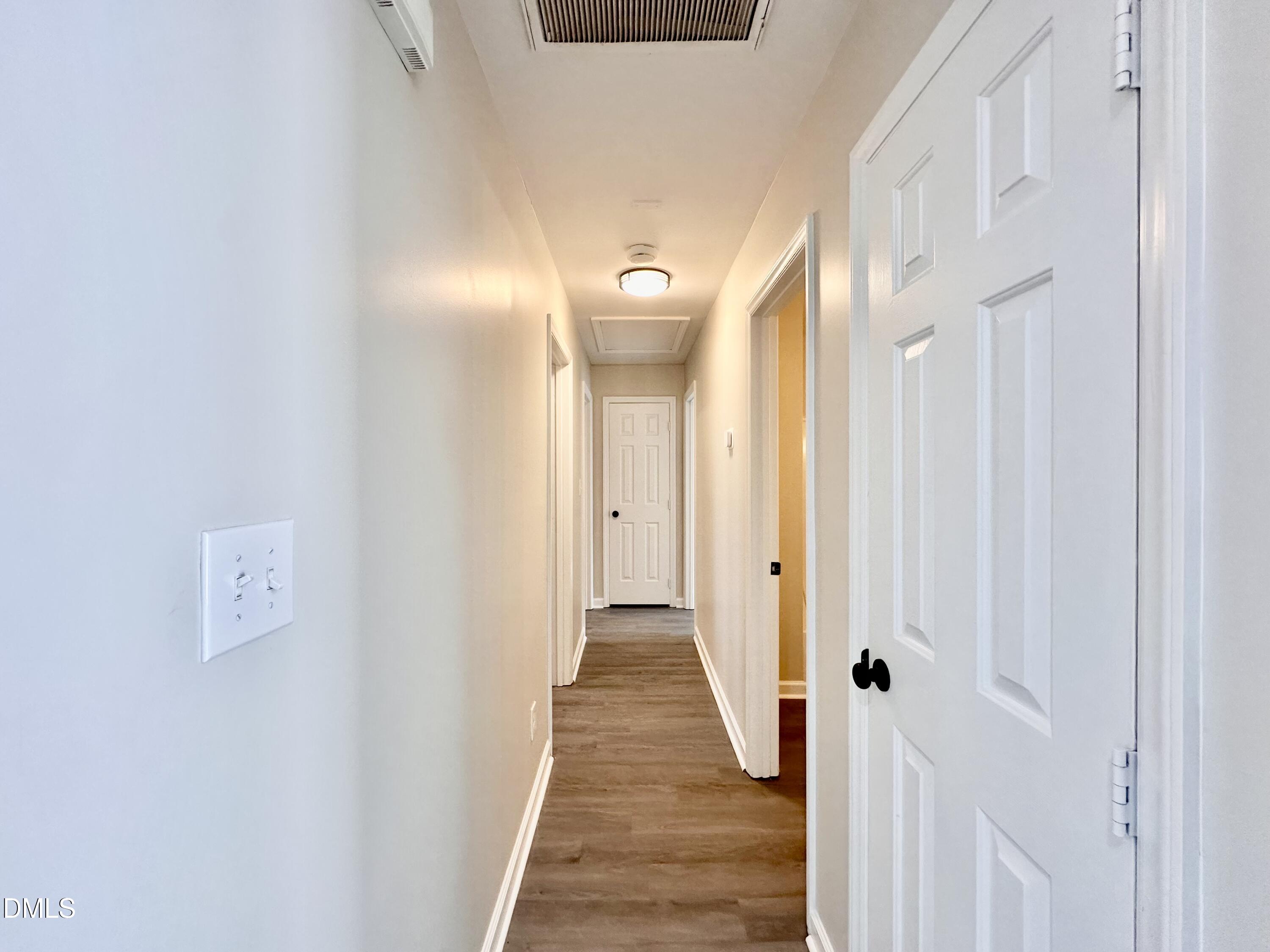 420 Tippett Road Zebulon, NC 27597 - Photo 7 of 14 a view of a hallway with wooden floor